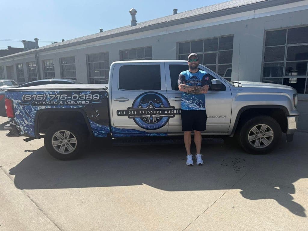 Randy, owner of All Day Pressure Washing, standing in front of his fully wrapped company truck